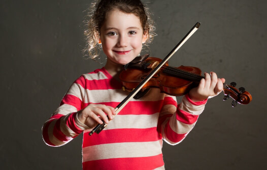 girl in stripped shirt plays a violin