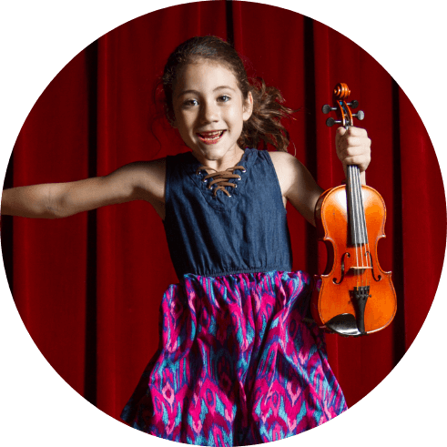Girl jumping in the air holding a violin