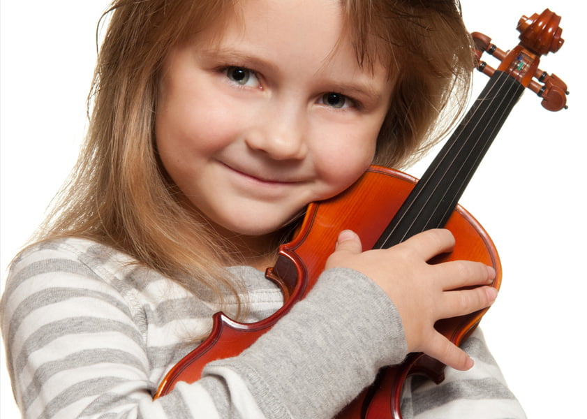 young girl hugs a violin