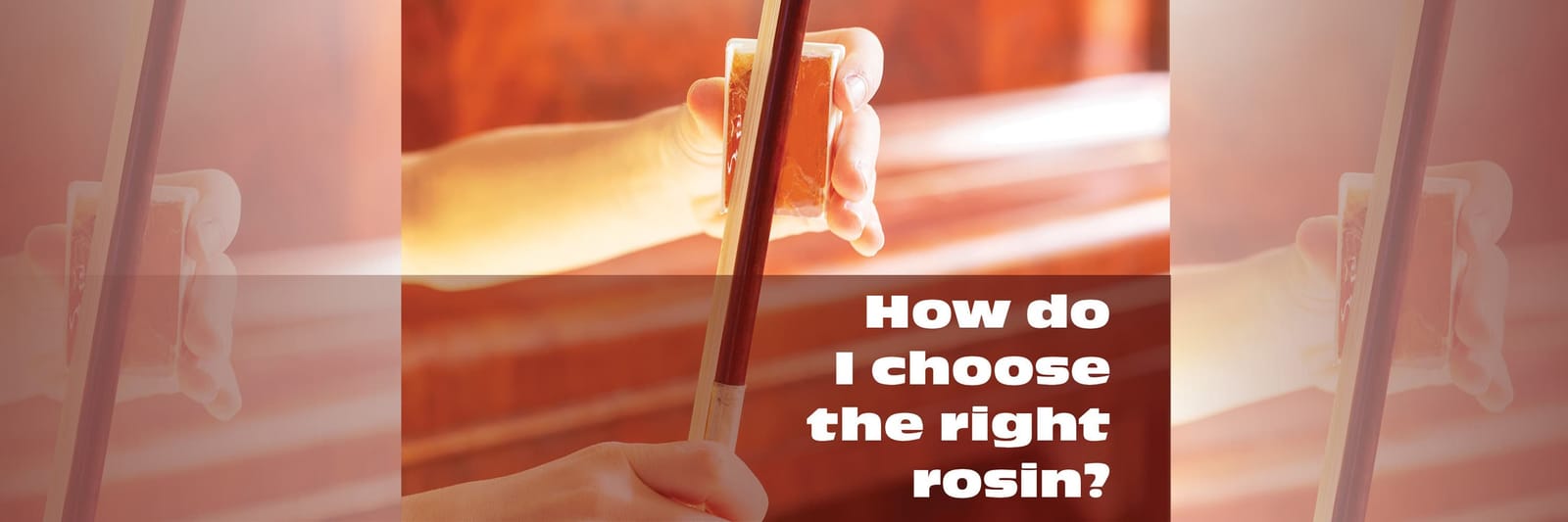A musician's hand applying a cake of rosin to the bow of their instrument