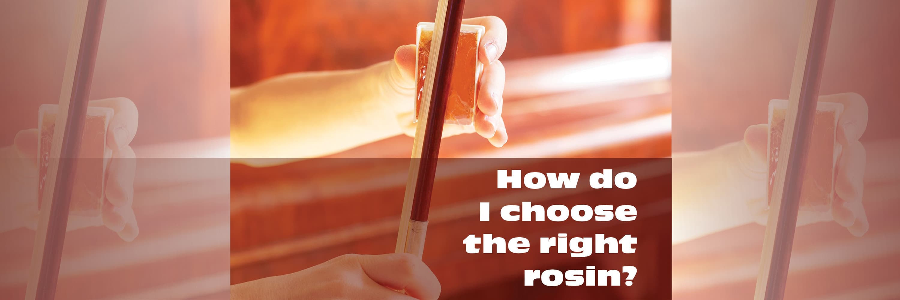 A musician's hand applying a cake of rosin to the bow of their instrument