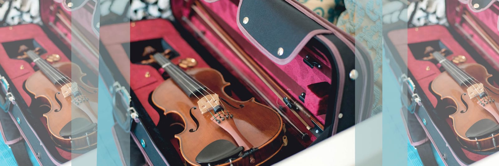 Violin and bows resting in an open case with a red velvet lining