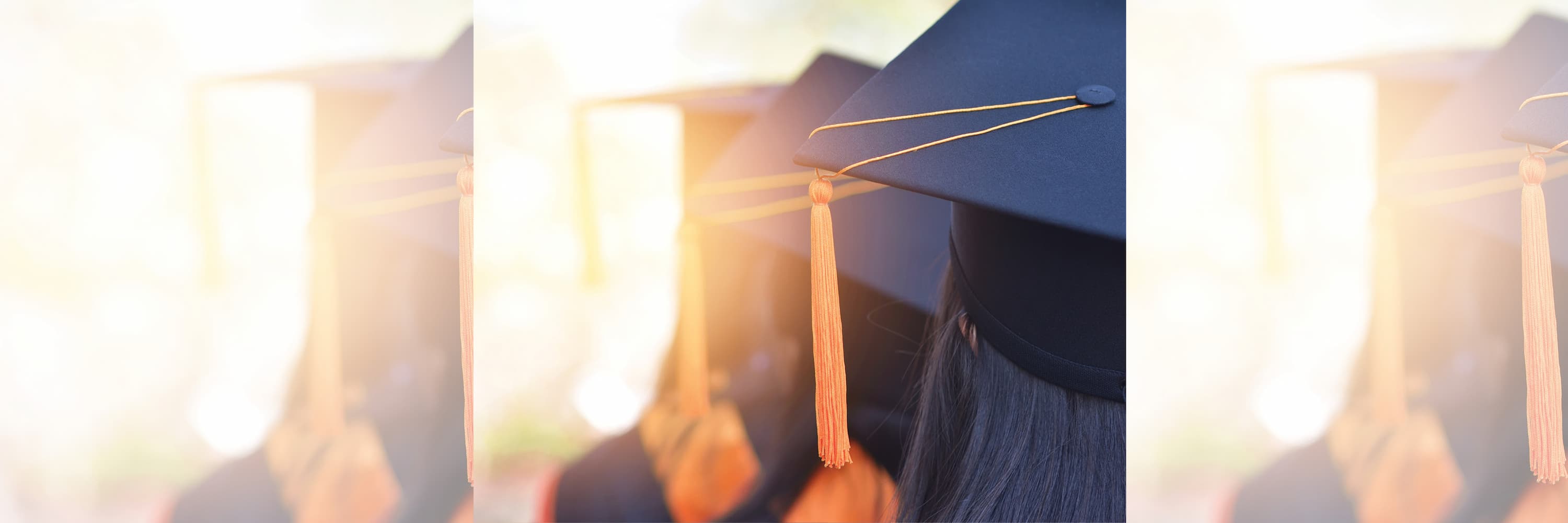 Graduates wearing caps with orange tassels during a commencement ceremony