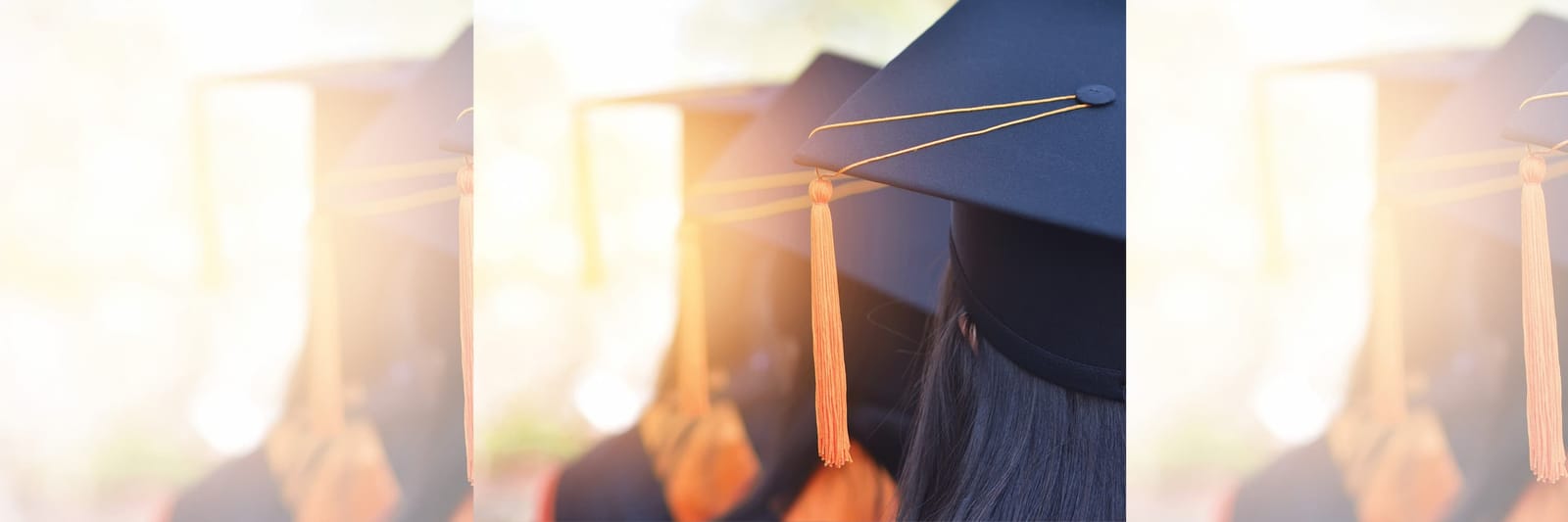 Graduates wearing caps with orange tassels during a commencement ceremony