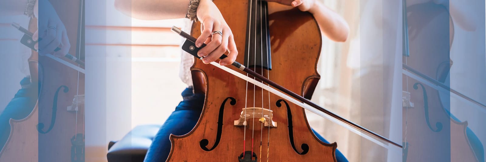 Close-up of a person playing a cello with a bow