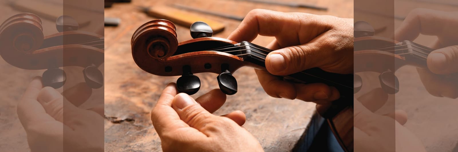 Person adjusting tuning pegs on a violin scroll