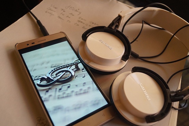A smartphone with headphones plugged in.