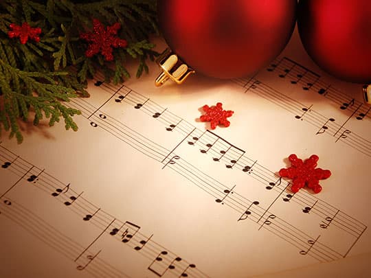 Holiday ornaments on top of sheet music