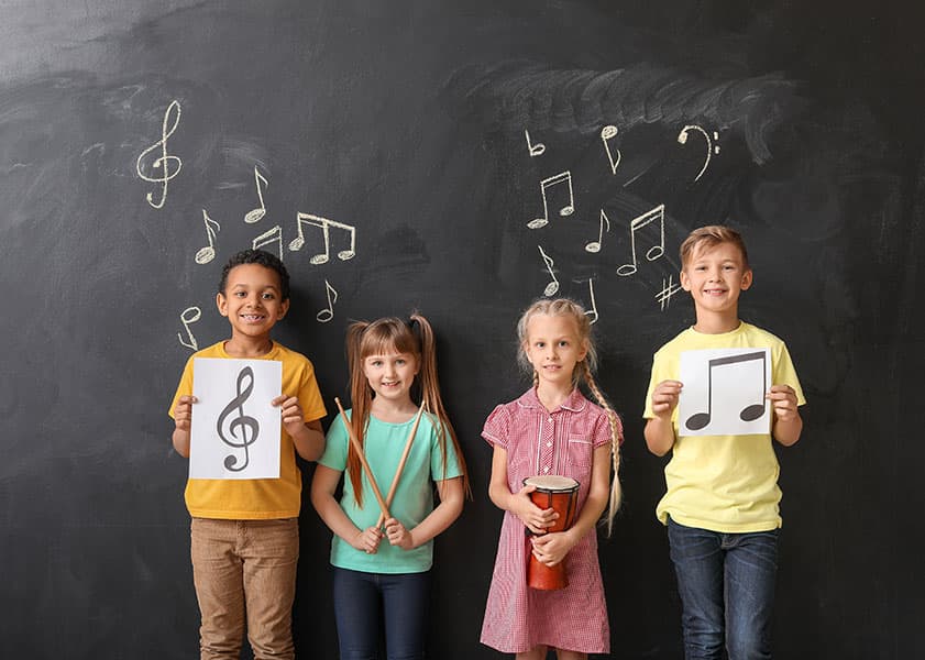 kids by chalkboard at music school