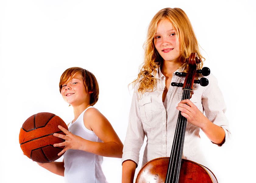 Girl holding a cello and boy holding a basketball against a white background