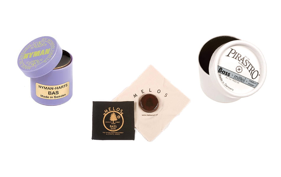 Assortment of upright bass rosin containers and cloths