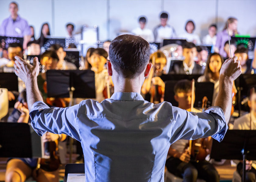 man conducting orchestra