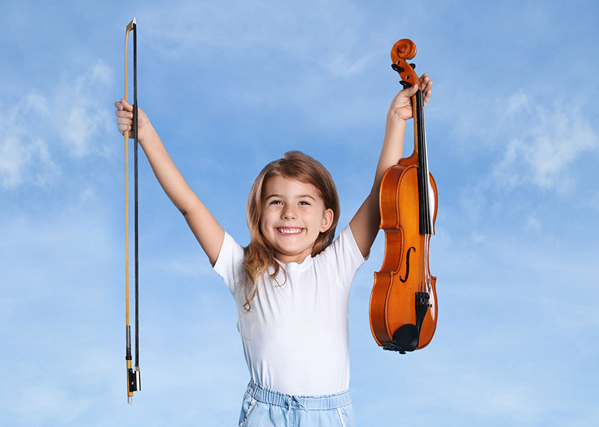 girl holding up violin and bow