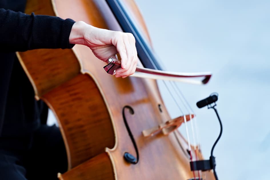 bow being drawn across cello strings