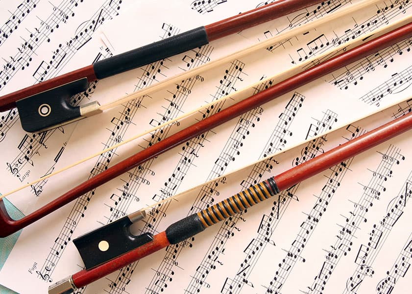 three bosws laying on sheet music